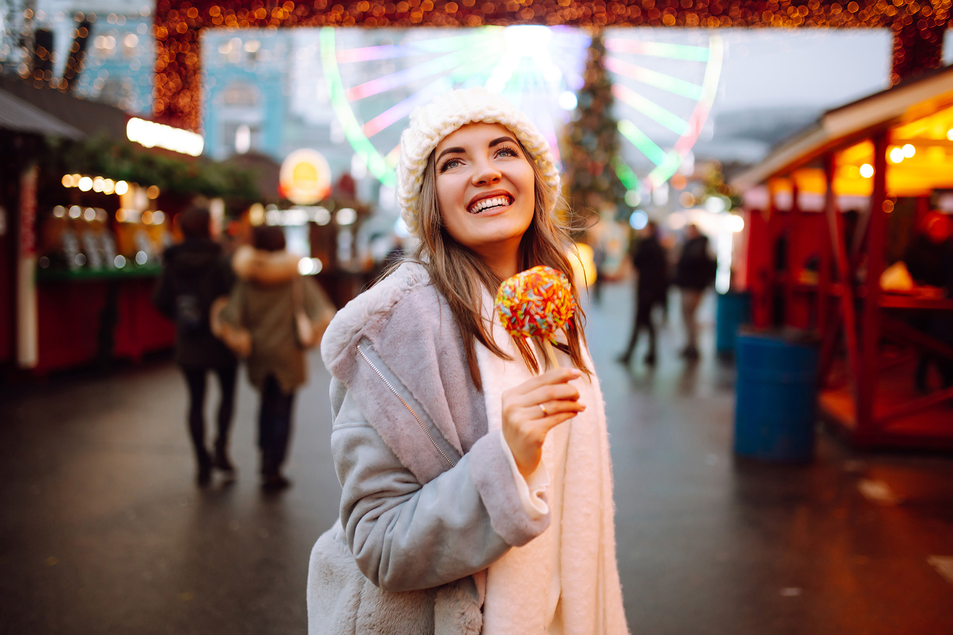 young-woman-with-caramel-apple-on-christmas-market-2022-11-09-04-58-01-utc